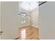 Bright bedroom features wood floors, modern lighting, and contrasting wallpaper accent wall at 10835 Se Highway 464C, Ocklawaha, FL 32179