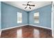 Sunny bedroom with hardwood floors, ceiling fan, and two windows for great natural light at 10835 Se Highway 464C, Ocklawaha, FL 32179