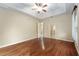 Empty bedroom with wood floors, a neutral wall color, a ceiling fan, and ample space for furniture at 10835 Se Highway 464C, Ocklawaha, FL 32179