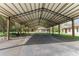 A spacious carport with metal roof provides ample covered parking and protection from the elements at 10835 Se Highway 464C, Ocklawaha, FL 32179