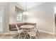 Cozy dining area featuring a built-in bench, a dining table with chairs, and a window with a view at 10835 Se Highway 464C, Ocklawaha, FL 32179