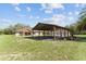 Charming single-story home with a spacious carport, verdant lawn, and mature landscaping for curb appeal at 10835 Se Highway 464C, Ocklawaha, FL 32179