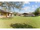 Sprawling estate features well-manicured lawn, multiple buildings including a barn-like structure, and mature trees at 10835 Se Highway 464C, Ocklawaha, FL 32179