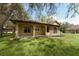 Home exterior with covered porch, stone accents, and a well-maintained lawn offers curb appeal at 10835 Se Highway 464C, Ocklawaha, FL 32179