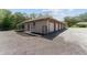 An exterior shot of the garage showing 6 garage doors for parking and vehicle storage at 10835 Se Highway 464C, Ocklawaha, FL 32179
