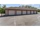 An exterior shot of the garage showing 6 garage doors for parking and vehicle storage at 10835 Se Highway 464C, Ocklawaha, FL 32179