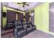 Home theater room featuring tiered seating with plush leather recliners, perfect for an immersive viewing experience at 10835 Se Highway 464C, Ocklawaha, FL 32179