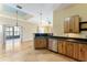Kitchen showcases granite counters, wood cabinets and overlooks living areas at 10835 Se Highway 464C, Ocklawaha, FL 32179