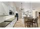 Modern kitchen featuring white cabinetry, granite countertops, and a breakfast bar at 10835 Se Highway 464C, Ocklawaha, FL 32179