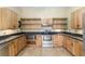 Kitchen with granite counters, wooden cabinets, and stainless steel appliances at 10835 Se Highway 464C, Ocklawaha, FL 32179