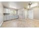 This laundry room features tile floors, a utility sink with shaker cabinets and a window for natural lighting at 10835 Se Highway 464C, Ocklawaha, FL 32179