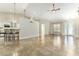 Open floor plan with tile flooring, high ceilings, and a partial wall separating the living space from the kitchen at 10835 Se Highway 464C, Ocklawaha, FL 32179