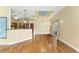 Bright open living space with hardwood floors and views into kitchen at 10835 Se Highway 464C, Ocklawaha, FL 32179