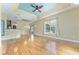 Bright living room boasts hardwood floors, fan, recessed ceilings and natural light at 10835 Se Highway 464C, Ocklawaha, FL 32179