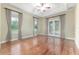 Bright and spacious main bedroom features hardwood floors, ceiling fan, and glass doors to outdoor space at 10835 Se Highway 464C, Ocklawaha, FL 32179
