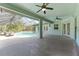 Covered patio view featuring a large, open area, a ceiling fan, and a view of the pool and backyard at 10835 Se Highway 464C, Ocklawaha, FL 32179