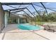A beautiful screened-in pool, integrated jacuzzi, and landscaped patio create a private outdoor oasis at 10835 Se Highway 464C, Ocklawaha, FL 32179