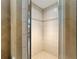 Tiled shower with a glass door features neutral tones and decorative tile work at 10835 Se Highway 464C, Ocklawaha, FL 32179