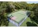 An aerial view of a well-maintained sports court ready for basketball or tennis games and recreation at 10835 Se Highway 464C, Ocklawaha, FL 32179