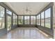 Bright sunroom features tile flooring, ceiling fan and many windows letting in plenty of natural light at 10835 Se Highway 464C, Ocklawaha, FL 32179