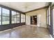 Bright sunroom features tile flooring, ceiling fan and many windows letting in plenty of natural light at 10835 Se Highway 464C, Ocklawaha, FL 32179