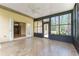 Bright sunroom features tile flooring, ceiling fan and many windows letting in plenty of natural light at 10835 Se Highway 464C, Ocklawaha, FL 32179