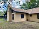 Back exterior of home with stucco and chimney at 1112 Ne 130Th Ter, Silver Springs, FL 34488