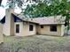 Back exterior of house with stucco siding and multiple windows at 1112 Ne 130Th Ter, Silver Springs, FL 34488