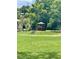 Backyard includes a gazebo surrounded by lush green lawn and mature trees at 1112 Ne 130Th Ter, Silver Springs, FL 34488