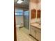 Bathroom with a shower, patterned linoleum, and wallpaper with floral accents at 1112 Ne 130Th Ter, Silver Springs, FL 34488