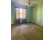 Bright bedroom with neutral walls and carpet, and large windows for ample natural light at 1112 Ne 130Th Ter, Silver Springs, FL 34488