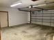 Functional garage includes garage door, epoxy flooring, and access door at 1112 Ne 130Th Ter, Silver Springs, FL 34488