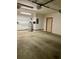 Clean garage features water heater, epoxy flooring, and access door at 1112 Ne 130Th Ter, Silver Springs, FL 34488