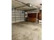 View of the spacious garage featuring a work bench and overhead garage door at 1112 Ne 130Th Ter, Silver Springs, FL 34488