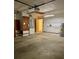 Spacious garage includes water heater, storage shelves, and access door at 1112 Ne 130Th Ter, Silver Springs, FL 34488