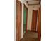 Hallway featuring wood-look floors and wooden bifold closet doors at 1112 Ne 130Th Ter, Silver Springs, FL 34488