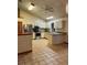 Open kitchen with stainless steel appliances, tile flooring, granite countertops, and bright lighting at 1112 Ne 130Th Ter, Silver Springs, FL 34488