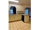 Spacious kitchen with updated appliances, counter seating, and tile floors near the sink and dishwasher at 1112 Ne 130Th Ter, Silver Springs, FL 34488