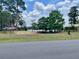 Scenic view of the lake and a charming picnic area with a covered pavilion, perfect for outdoor gatherings at 1112 Ne 130Th Ter, Silver Springs, FL 34488