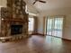 Inviting living room featuring hardwood floors and a cozy stone fireplace at 1112 Ne 130Th Ter, Silver Springs, FL 34488