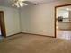 Cozy living room with neutral carpet and views into the kitchen, perfect for entertaining at 1112 Ne 130Th Ter, Silver Springs, FL 34488