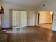 Open-concept living area features laminate flooring, a stone fireplace, and sliding door access at 1112 Ne 130Th Ter, Silver Springs, FL 34488