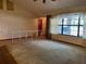 Open living room featuring vaulted ceilings, large window, and staircase with decorative white railing at 1112 Ne 130Th Ter, Silver Springs, FL 34488