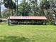 Outdoor pavilion with covered seating area in a grassy field at 1112 Ne 130Th Ter, Silver Springs, FL 34488