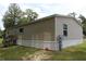 Back of home view shows siding with stairs to the back door and exterior utilities at 11160 Nw 8Th Ln, Ocala, FL 34482
