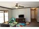 Cozy living room with a ceiling fan and natural light from the large windows at 11160 Nw 8Th Ln, Ocala, FL 34482