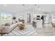 This open-concept living space includes a living room, modern kitchen and stools for easy entertaining at 1703 Sw 159 Ct, Ocala, FL 34481