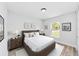 Bedroom features a bed, side tables with lamps, decor and a window with a view at 1703 Sw 159 Ct, Ocala, FL 34481