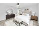 Well-appointed main bedroom with modern decor, stylish furnishings, and wood-look flooring at 1703 Sw 159 Ct, Ocala, FL 34481