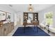 Modern home office with stylish decor, a built-in bookshelf, and a comfortable seating area at 1703 Sw 159 Ct, Ocala, FL 34481